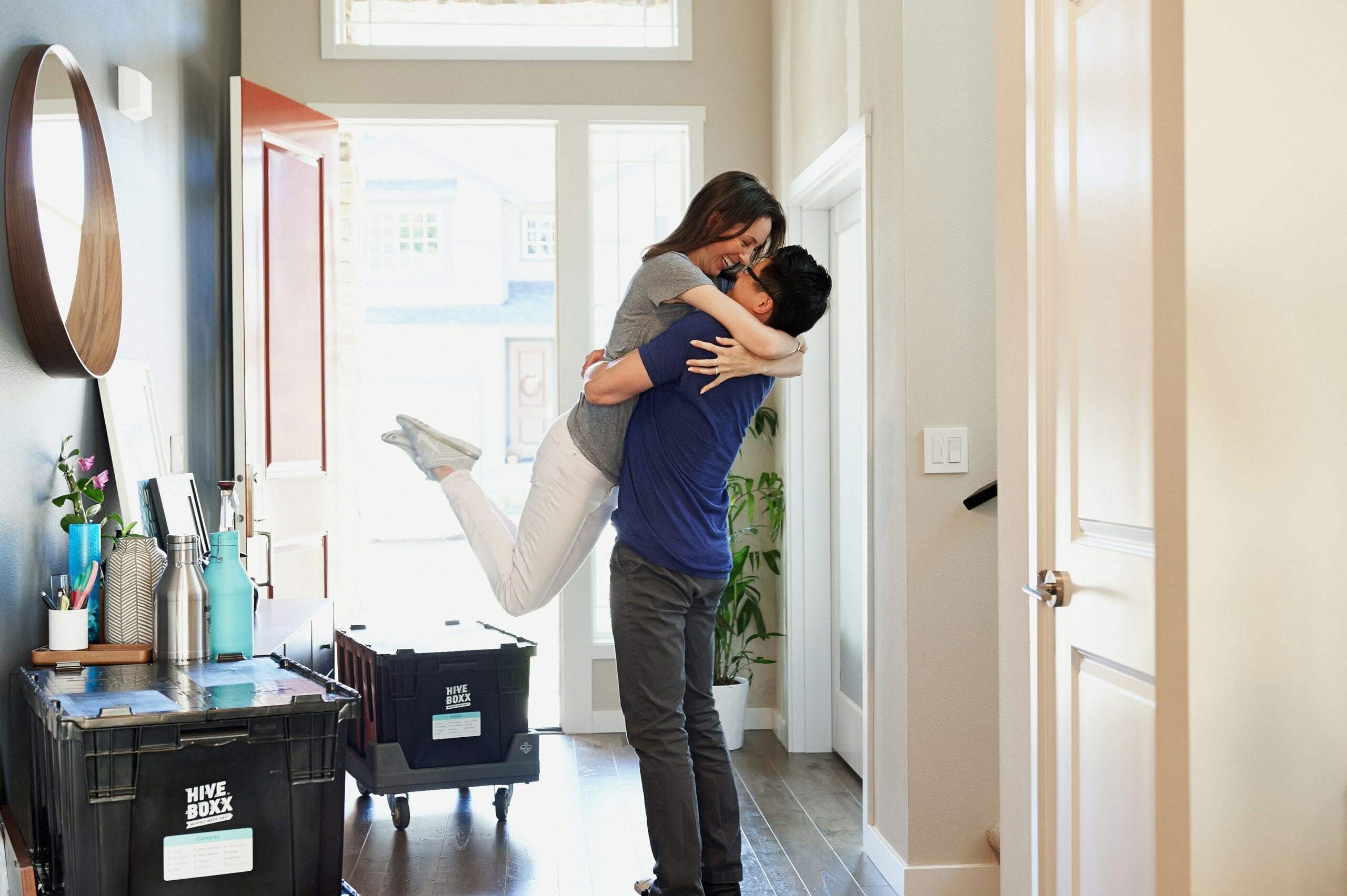 A couple touring a home with a real estate agent on a sunny spring day