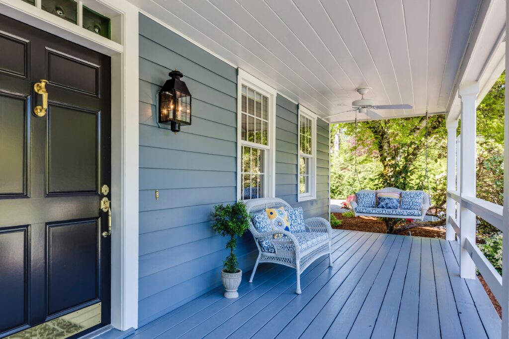 Front porch of home with swing and loveseat